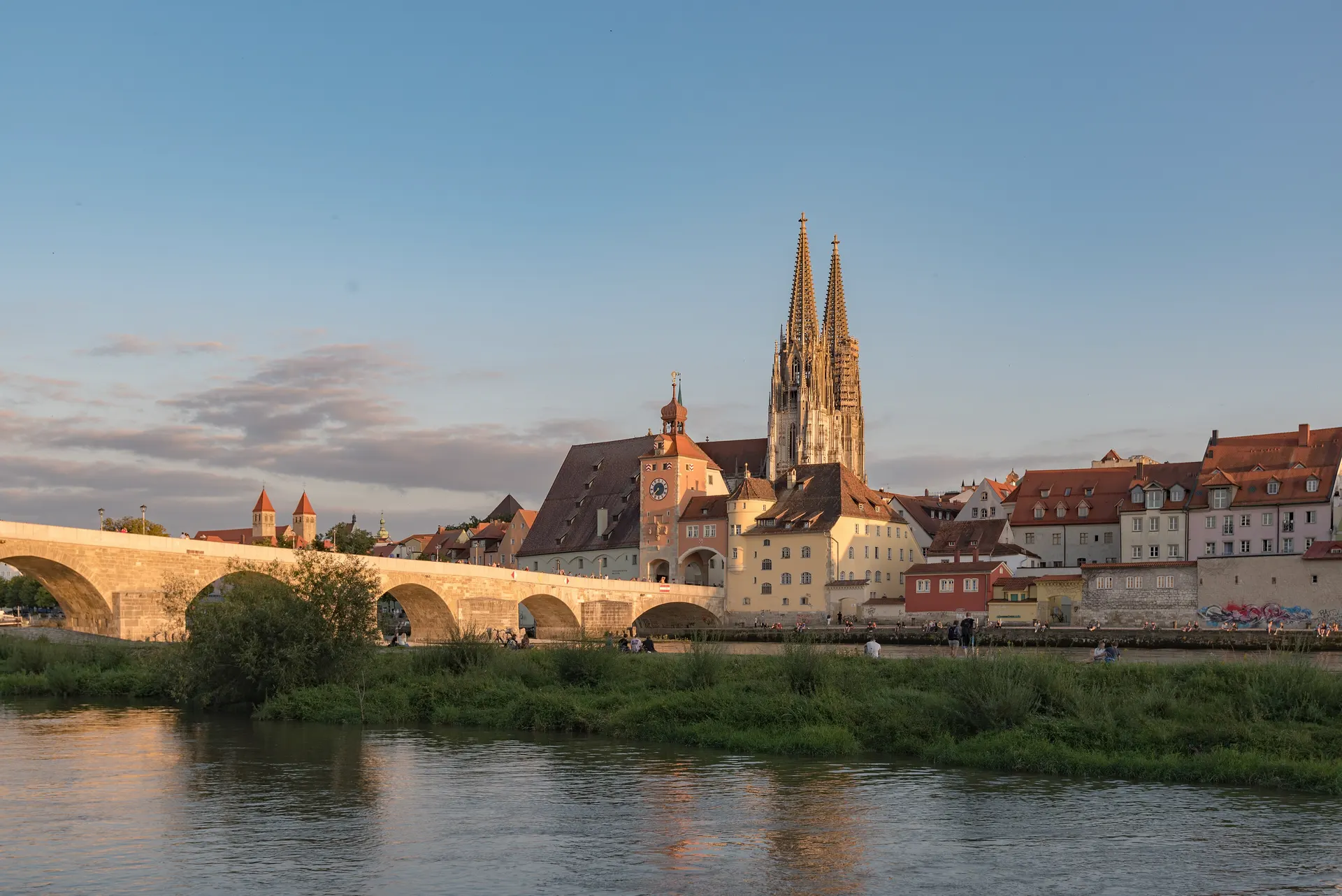 Stone Bridge over the Danube with Regensburg Cathedral and reflections in the evening light